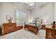 Comfortable bedroom with a four-poster bed, shuttered windows, and classic wooden furniture at 1092 N Roosevelt Ave, Chandler, AZ 85226