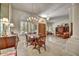 Elegant dining area featuring a large window, chandelier, and seamless flow into the living room at 1092 N Roosevelt Ave, Chandler, AZ 85226