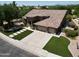 Aerial view of the home showing the three car garage, tile roof and manicured landscaping at 1092 N Roosevelt Ave, Chandler, AZ 85226