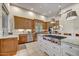 Gourmet kitchen with stainless steel appliances, granite countertops, and a large center island cooktop at 1092 N Roosevelt Ave, Chandler, AZ 85226