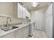 Functional laundry room with granite counters, ample cabinet space, and modern washer and dryer at 1092 N Roosevelt Ave, Chandler, AZ 85226