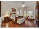 Spacious main bedroom with hardwood floors, shuttered windows, and a decorative ceiling fan at 1092 N Roosevelt Ave, Chandler, AZ 85226