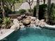 Inviting pool with a rock waterfall feature creating a serene backyard oasis at 1092 N Roosevelt Ave, Chandler, AZ 85226
