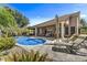 Beautiful backyard pool with lounge chairs on the stone deck, perfect for relaxation at 1092 N Roosevelt Ave, Chandler, AZ 85226