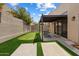Backyard featuring a putting green, shaded patio and privacy wall at 11762 E Becker Ln, Scottsdale, AZ 85259