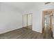 Bright bedroom featuring mirrored closet and hardwood floors at 11762 E Becker Ln, Scottsdale, AZ 85259