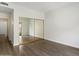 Bright bedroom featuring wood-look flooring and a mirrored closet; perfect for a relaxing retreat at 11762 E Becker Ln, Scottsdale, AZ 85259