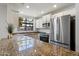 Modern kitchen featuring stainless steel appliances, granite countertops, and ample natural light at 11762 E Becker Ln, Scottsdale, AZ 85259