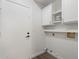 Laundry room with white cabinets, shelving and hardwood floors at 11762 E Becker Ln, Scottsdale, AZ 85259