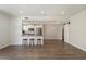 Open-concept living room featuring a kitchen with granite counters and stainless steel appliances and modern flooring at 11762 E Becker Ln, Scottsdale, AZ 85259