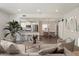 Staged living room with an open floor plan, seamlessly connecting the kitchen, dining, and living areas at 11762 E Becker Ln, Scottsdale, AZ 85259