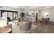 Staged living room with an open floor plan, seamlessly connecting the kitchen, dining, and living areas at 11762 E Becker Ln, Scottsdale, AZ 85259