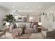 Cozy living room with plush sofa, stylish decor, and modern open-concept kitchen and dining at 11762 E Becker Ln, Scottsdale, AZ 85259