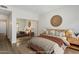 Staged bedroom with a large mirror closet, decorative wall art, and comfortable furnishings at 11762 E Becker Ln, Scottsdale, AZ 85259