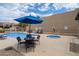 Community pool with spa, lounge chairs, tables and desert landscaping at 11762 E Becker Ln, Scottsdale, AZ 85259