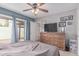 This is a bedroom featuring a large dresser, photos, and access to the back patio at 13408 N 25Th Dr, Phoenix, AZ 85029