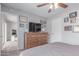 This is a bedroom with a large dresser, photos, and a ceiling fan at 13408 N 25Th Dr, Phoenix, AZ 85029