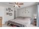 Bedroom features a ceiling fan, a large bed, and wall decor at 13408 N 25Th Dr, Phoenix, AZ 85029