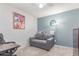 Bedroom features a couch, desk, and artwork at 13408 N 25Th Dr, Phoenix, AZ 85029