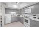 Well-lit kitchen features white appliances and countertops and modern gray cabinetry at 13408 N 25Th Dr, Phoenix, AZ 85029
