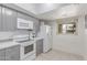 Bright kitchen features white cabinets, white appliances and backsplash, and tile floor at 13408 N 25Th Dr, Phoenix, AZ 85029