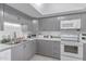 Well-equipped kitchen with gray cabinetry and white appliances at 13408 N 25Th Dr, Phoenix, AZ 85029