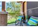 Outdoor balcony features outdoor seating with comfortable pillows and a calming view at 14250 W Wigwam Blvd # 2722, Litchfield Park, AZ 85340