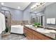 Bright bathroom features a double sink vanity, soaking tub, and glass enclosed shower at 14250 W Wigwam Blvd # 2722, Litchfield Park, AZ 85340