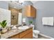 Neutral bathroom featuring wood cabinets, a single sink vanity, and a tile shower at 14250 W Wigwam Blvd # 2722, Litchfield Park, AZ 85340