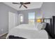 Well-lit bedroom with a large window and a view, complemented by neutral tones and plush bedding at 14250 W Wigwam Blvd # 2722, Litchfield Park, AZ 85340