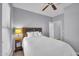 This cozy bedroom includes a lamp-lit nightstand and a comfortable bed with soft, white bedding at 14250 W Wigwam Blvd # 2722, Litchfield Park, AZ 85340
