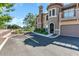 Elegant condo building with manicured landscaping, featuring arched entryways and a private garage for convenience at 14250 W Wigwam Blvd # 2722, Litchfield Park, AZ 85340