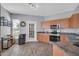 Well-lit kitchen with wood flooring and stainless steel appliances, adjacent to a door to the backyard at 14250 W Wigwam Blvd # 2722, Litchfield Park, AZ 85340