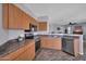 Kitchen with stainless steel appliances and a view to the living room at 14250 W Wigwam Blvd # 2722, Litchfield Park, AZ 85340