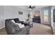 Cozy living room with soft lighting, comfortable furniture, TV, and modern ceiling fan at 14250 W Wigwam Blvd # 2722, Litchfield Park, AZ 85340
