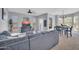 Comfortable living room with modern gray furniture, TV, ceiling fan and lots of light at 14250 W Wigwam Blvd # 2722, Litchfield Park, AZ 85340