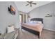 A stylish main bedroom boasts a ceiling fan, TV, and balcony access for a relaxing retreat at 14250 W Wigwam Blvd # 2722, Litchfield Park, AZ 85340