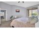 A serene main bedroom features a sliding glass door to a private balcony and a sunset view TV at 14250 W Wigwam Blvd # 2722, Litchfield Park, AZ 85340