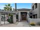 Inviting entrance to building featuring stone accents, mature landscaping, and gated access for residents at 14815 N Fountain Hills Blvd # 101, Fountain Hills, AZ 85268