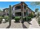 Two-story condo building featuring desert landscaping, private balconies, and covered entryways at 14815 N Fountain Hills Blvd # 101, Fountain Hills, AZ 85268