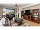 Comfortable living room with wood floors, leather furniture, ceiling fan, and access to outdoor seating at 14815 N Fountain Hills Blvd # 101, Fountain Hills, AZ 85268