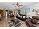 Open concept living room features wood floors, leather furniture, ceiling fan, and lots of natural light at 14815 N Fountain Hills Blvd # 101, Fountain Hills, AZ 85268
