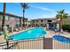 Community pool featuring a clear blue swimming area, lounge chairs, and nearby jacuzzi for residents at 14815 N Fountain Hills Blvd # 101, Fountain Hills, AZ 85268