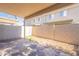 A cozy covered backyard featuring a stone patio and block wall fence at 16021 N 30Th St # 122, Phoenix, AZ 85032