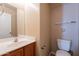 Half bathroom featuring a single sink vanity and toilet at 16021 N 30Th St # 122, Phoenix, AZ 85032