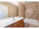 Bright bathroom with a vanity, sink, and tiled shower over tub at 16021 N 30Th St # 122, Phoenix, AZ 85032