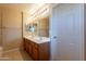 Bathroom featuring double sink vanity, tan tile floors, and decorative lighting above mirror at 16021 N 30Th St # 122, Phoenix, AZ 85032