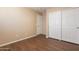 Bedroom featuring hard surface floors and closet with double doors at 16021 N 30Th St # 122, Phoenix, AZ 85032