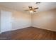 Bedroom featuring wood-look floors, neutral walls, one white door and natural light from one window at 16021 N 30Th St # 122, Phoenix, AZ 85032