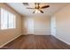 Bedroom featuring wood-look floors, neutral walls, two white doors and natural light from one window at 16021 N 30Th St # 122, Phoenix, AZ 85032
